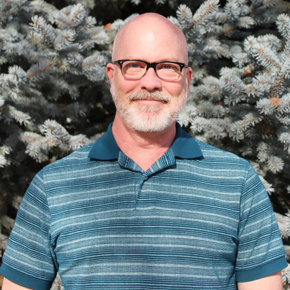 Greg Wilson standing in front of trees