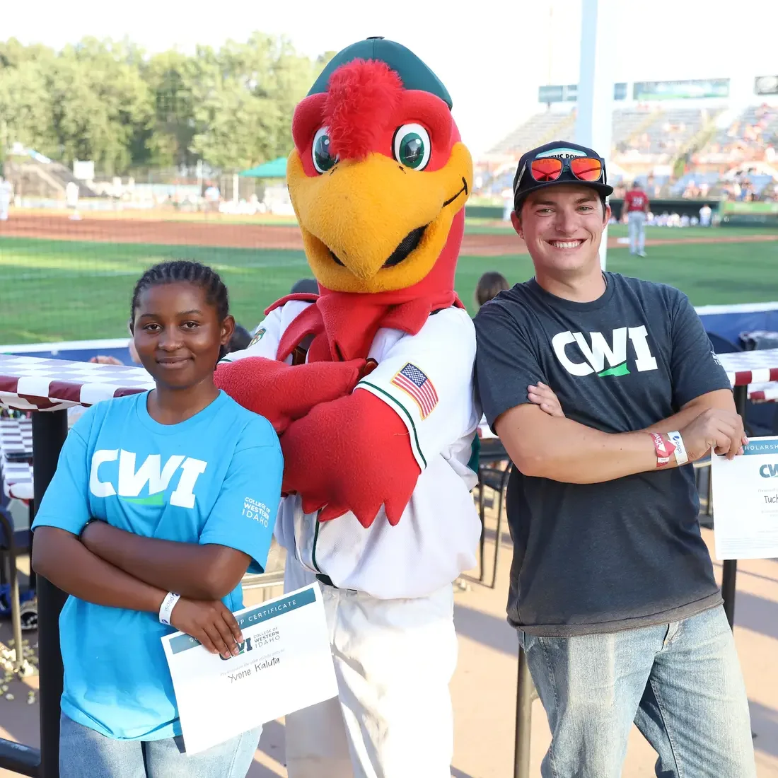 SCORE Big Scholarship recipients, Yvone Kaulta and Tucker Marcus with Humphrey the Hawk
