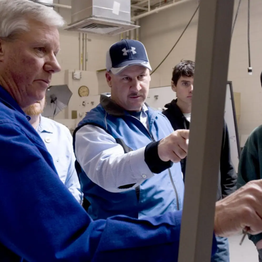 Instructors and students in a lab on campus