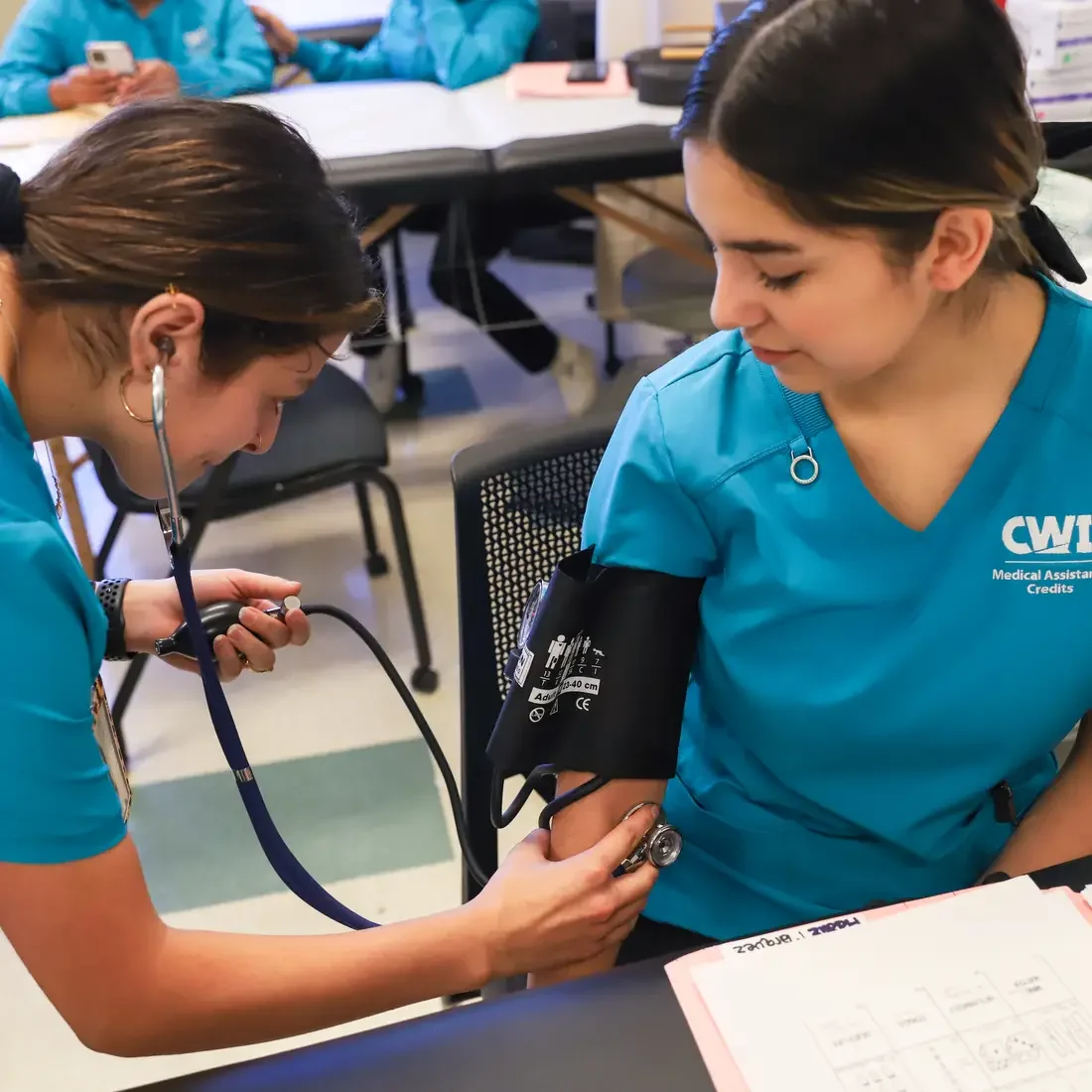 Medical assistant students working together in lab