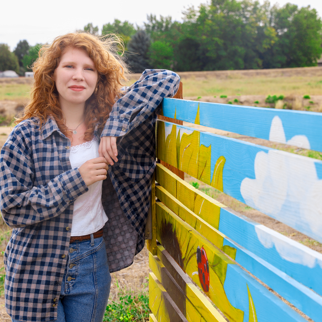 Hannah Wilson leaning on mural 