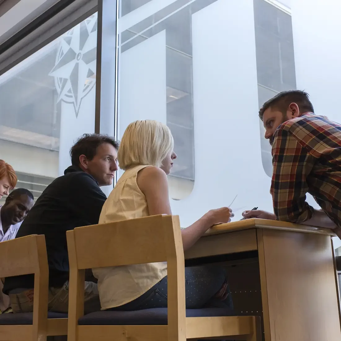 Students at desk in the Nampa Campus Lobby