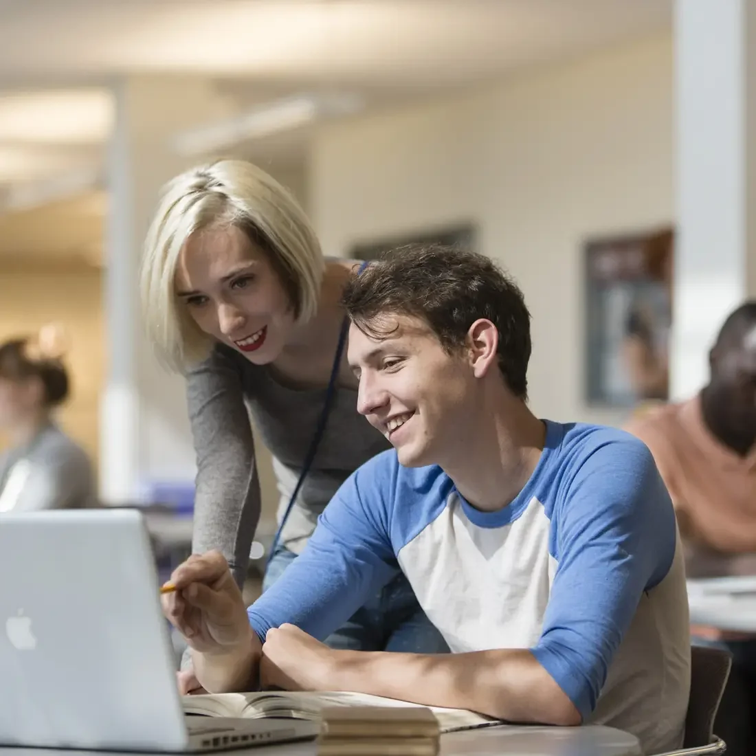 Student and staff looking at computer