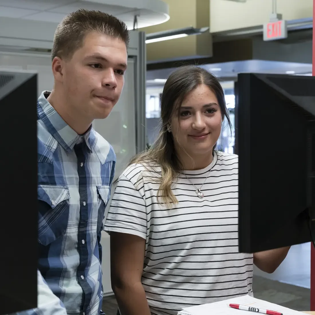 Students on computers at One Stop Student Services