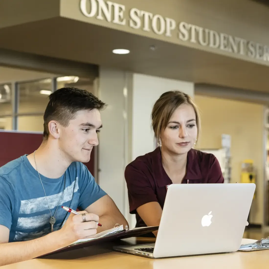 Staff assisting a student at One Stop Student Services