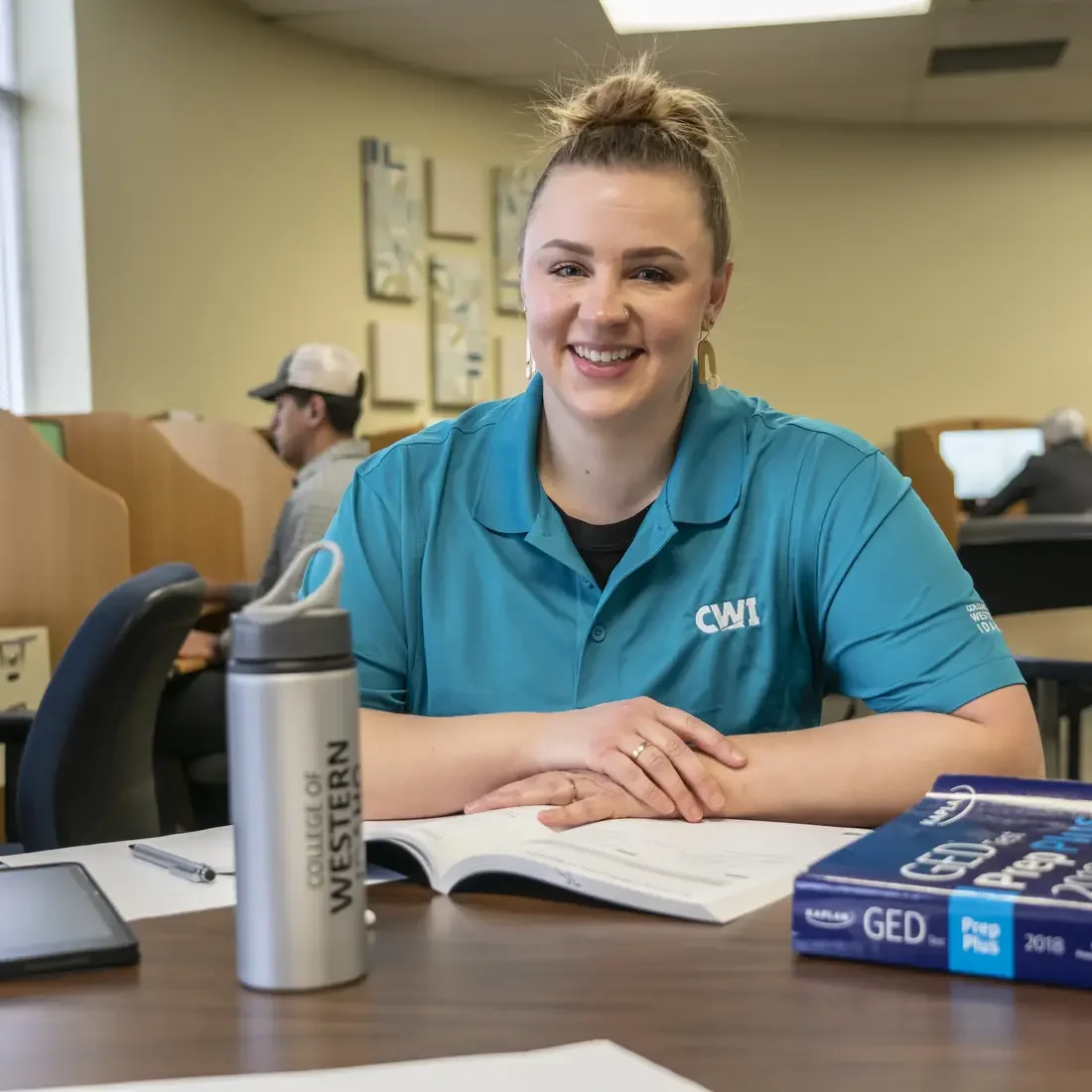 Person sitting in testing center smiling at camera