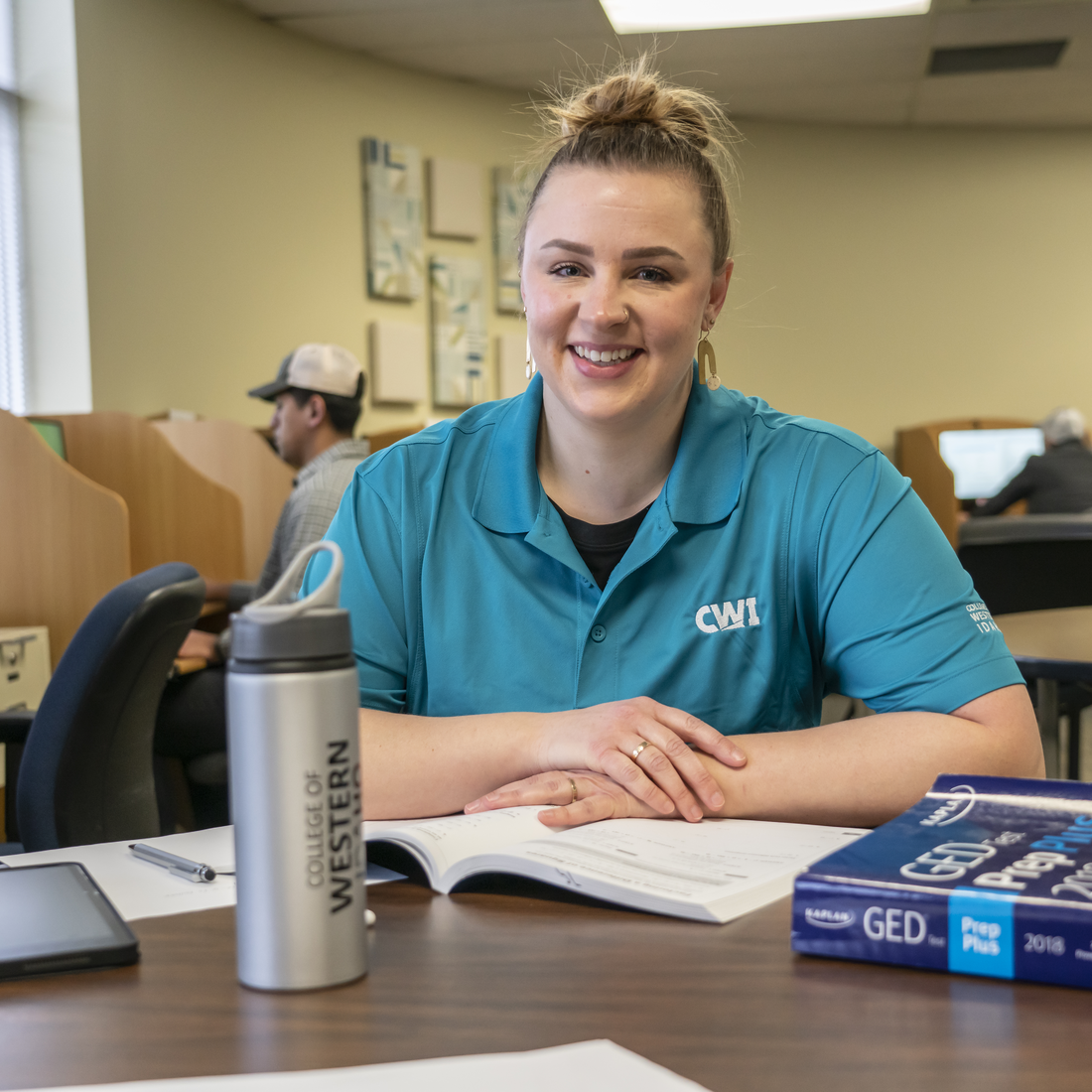 Person sitting in testing center smiling at camera