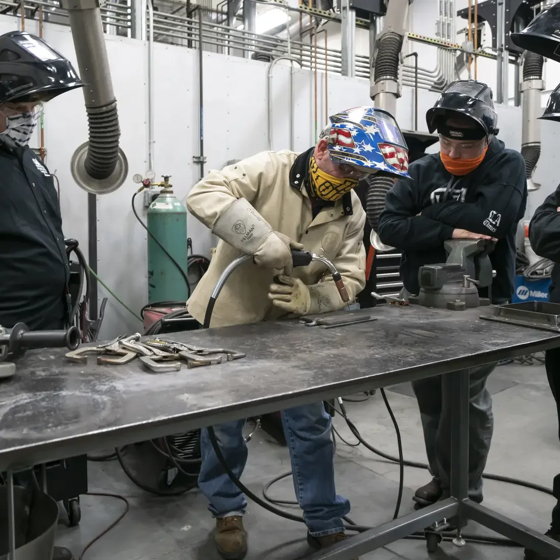 Students and faculty welding