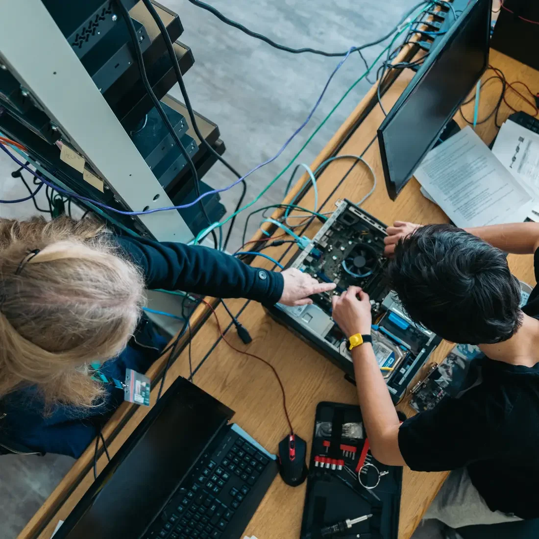 Instructor teaching student about computer systems
