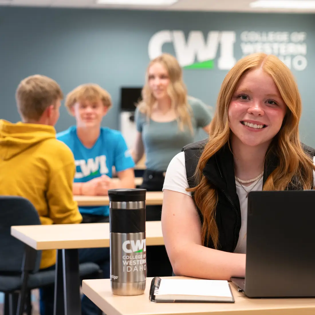 Student in common area on a laptop