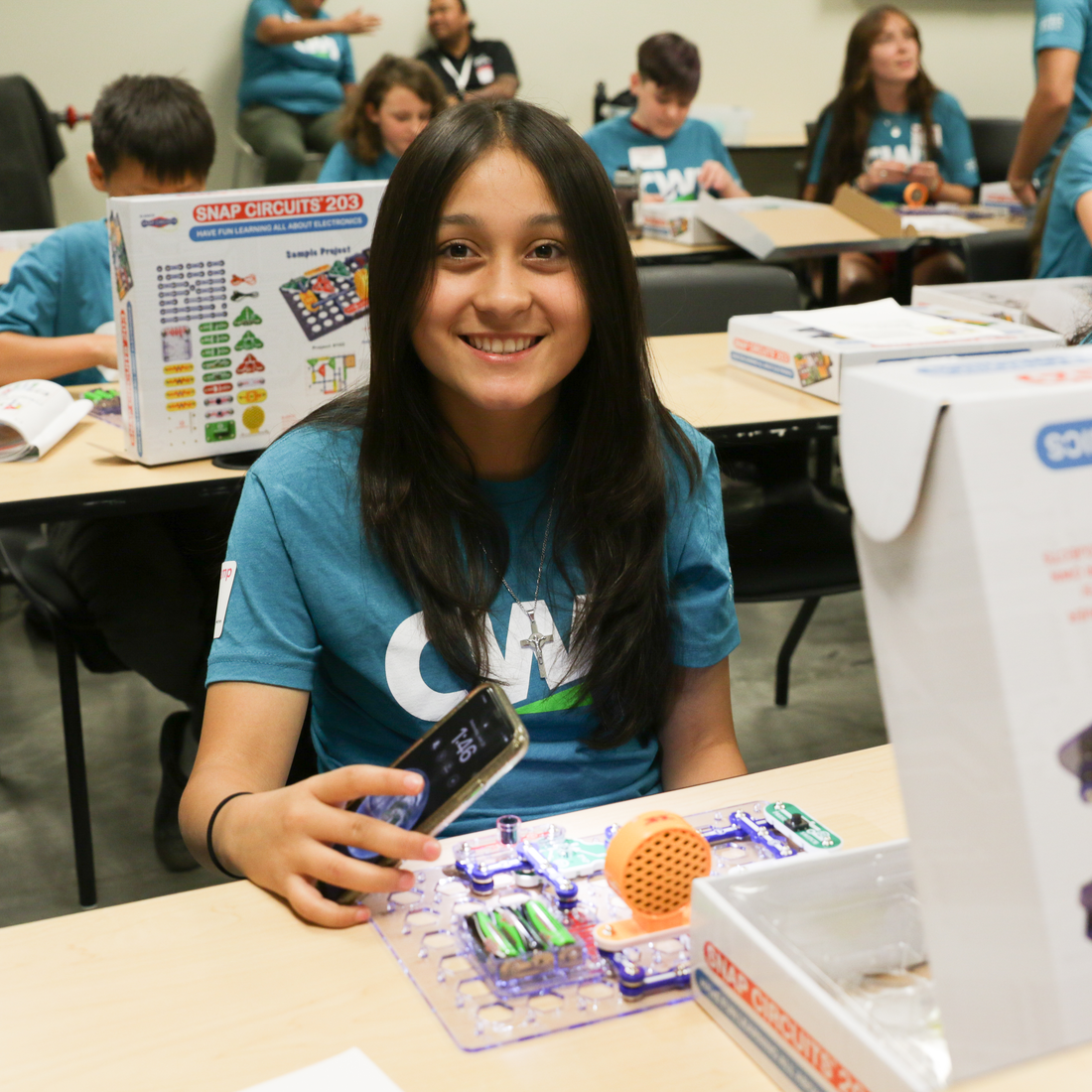 Smiling child working with electronics