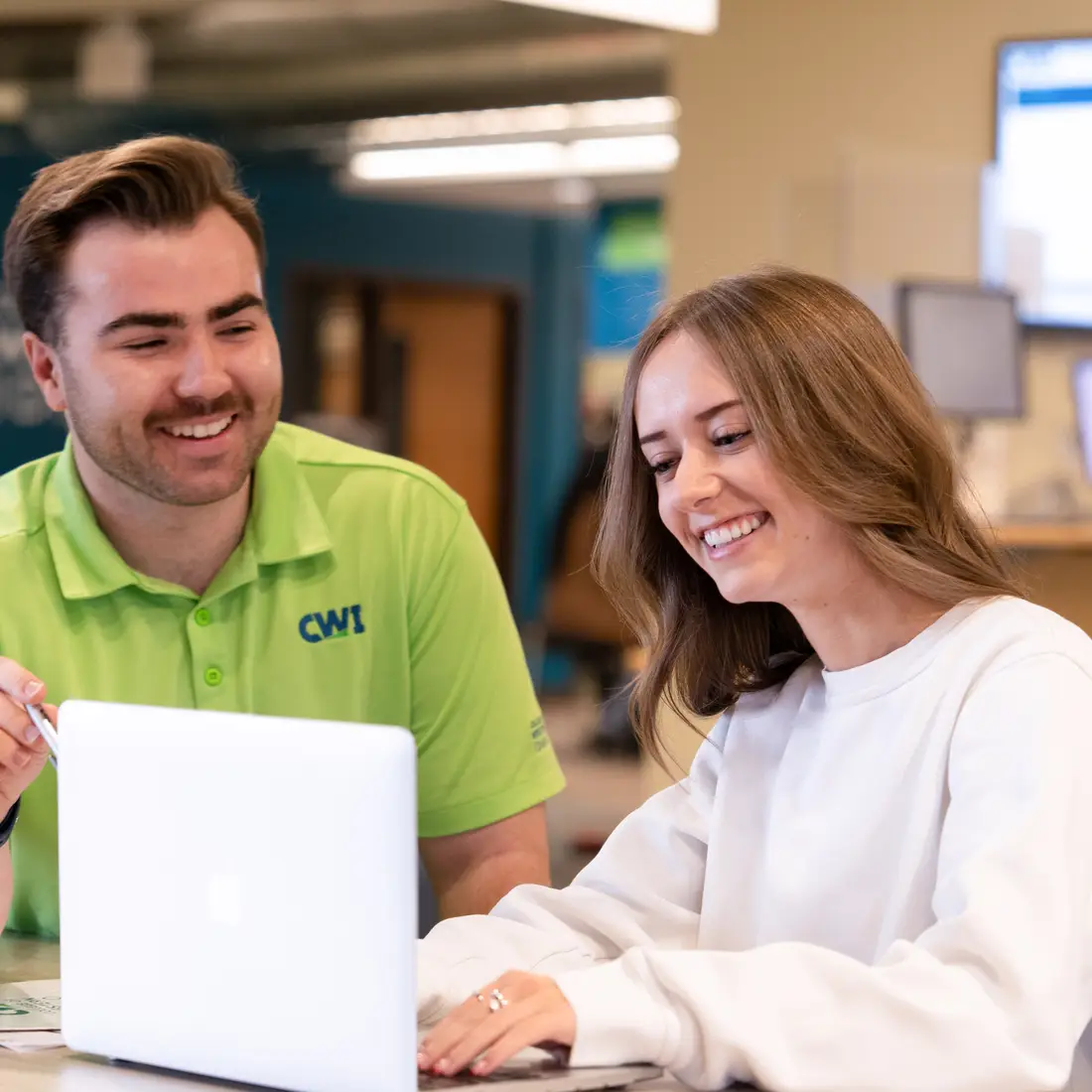 Two people at a laptop