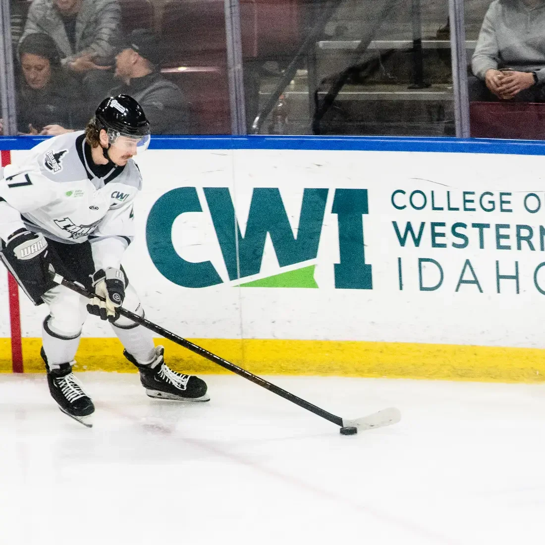 Hockey player on the ice with CWI logo