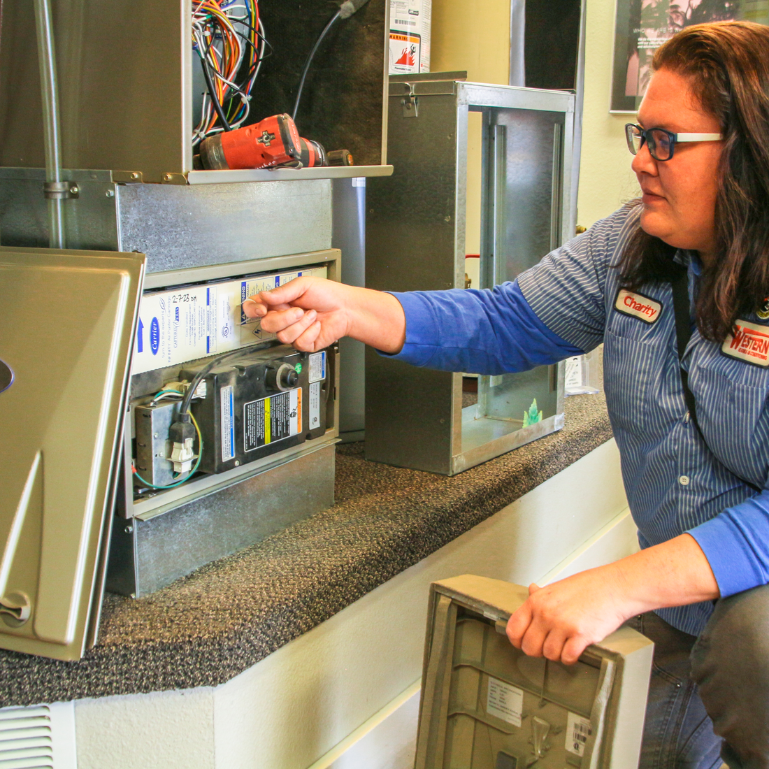 Charity Nicholson working on a HVAC repair