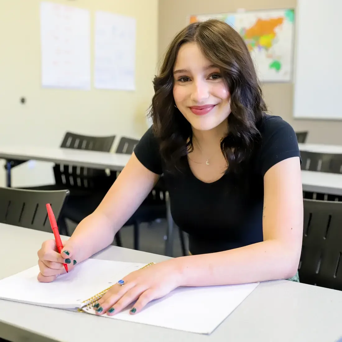 Maganne Akins writing in a notebook