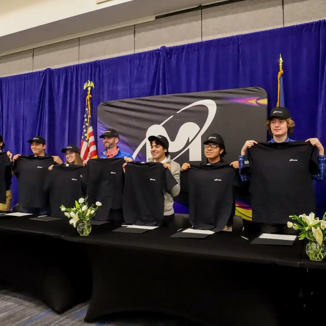 Micron Apprentices holding up t-shirts for signing day
