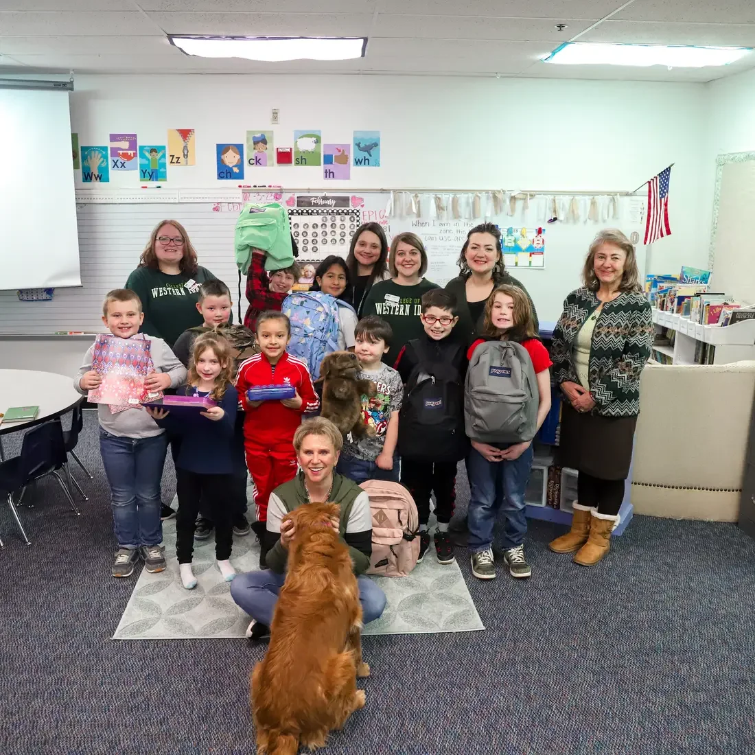 Central Elementary School students and staff holding up donated school supplies