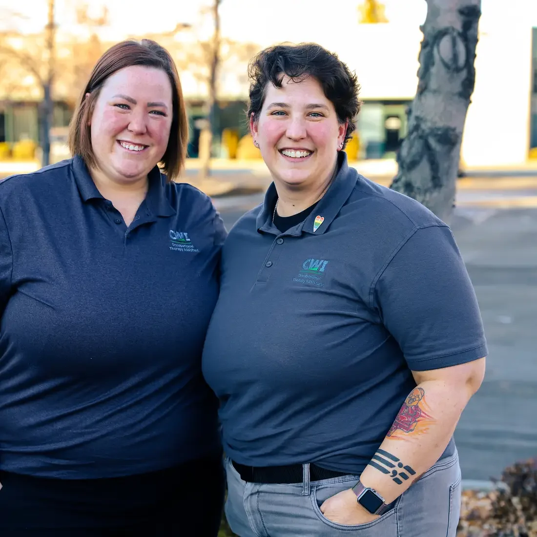 Leslee Tate and Kim Shores standing in front of a tree