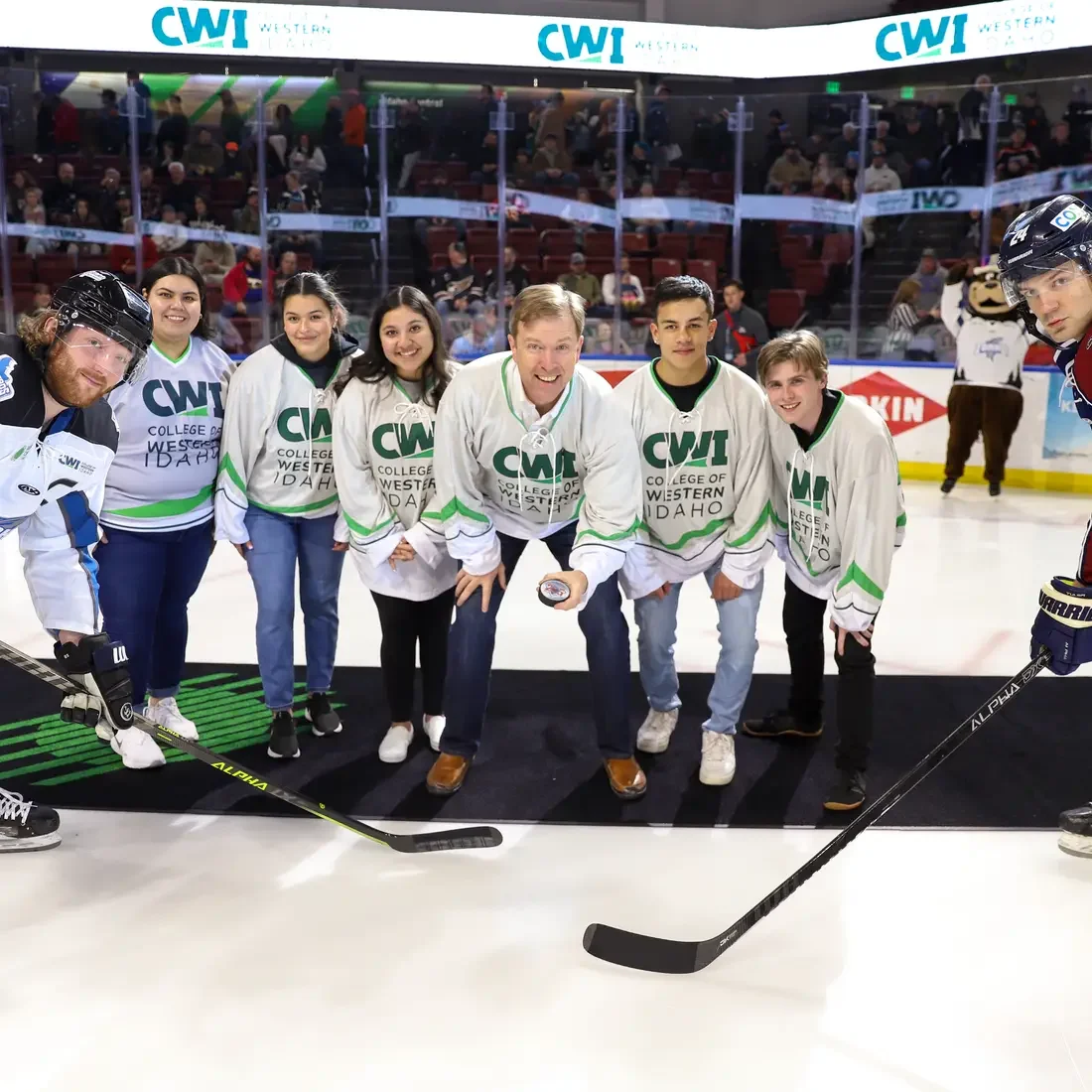 President Gordon Jones and students doing the puck drop at Steelheads game