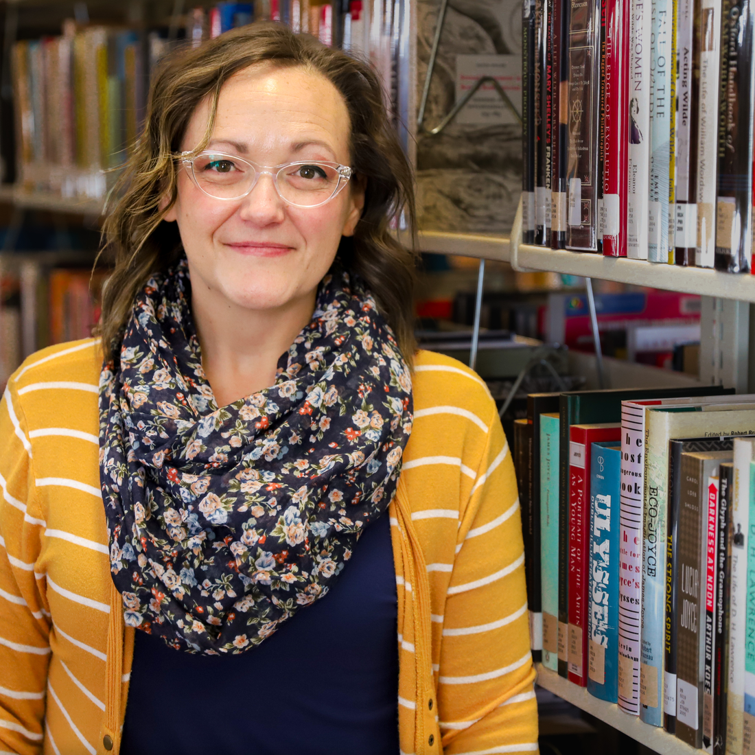 Autumn Brackley standing in front of book shelf