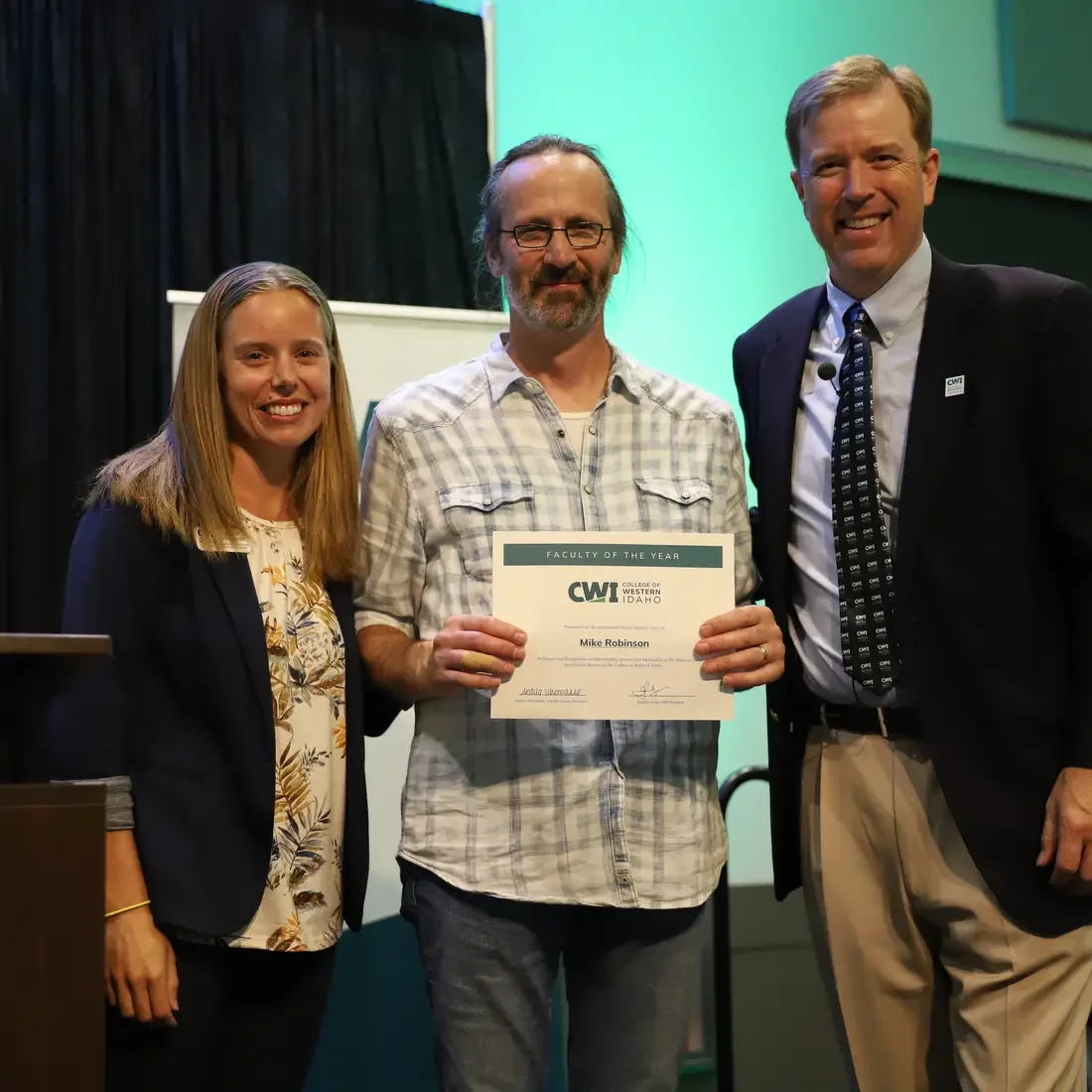 2022 Faculty of the Year, Michael Robinson, with Faculty Senate President, Andrea Schumaker, left, and President Gordon Jones
