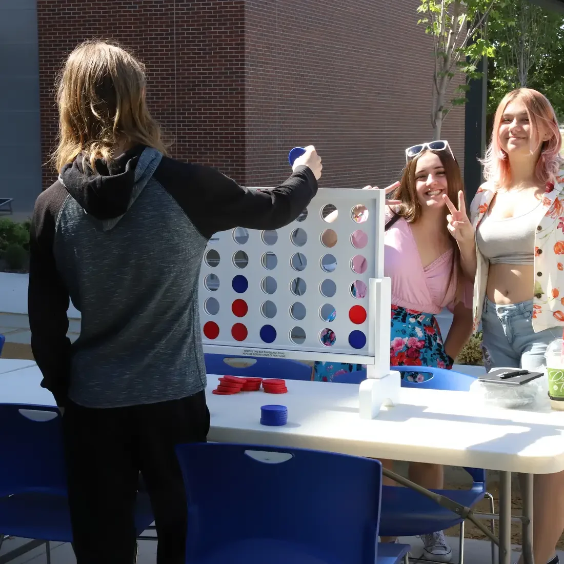 CWI students playing connect four outside