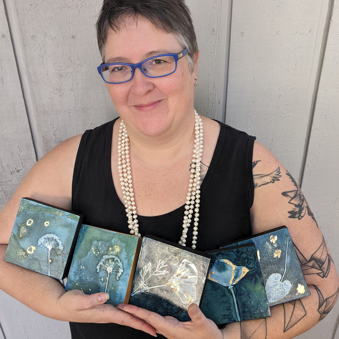 Jessie Swimeley holding pieces of her art