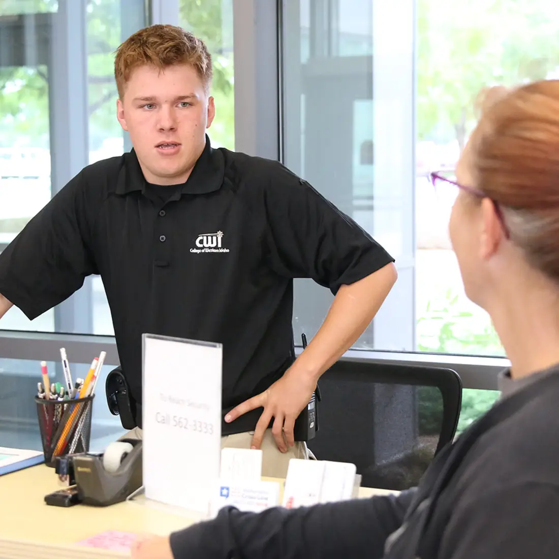 CWI security officer assisting student at campus security desk