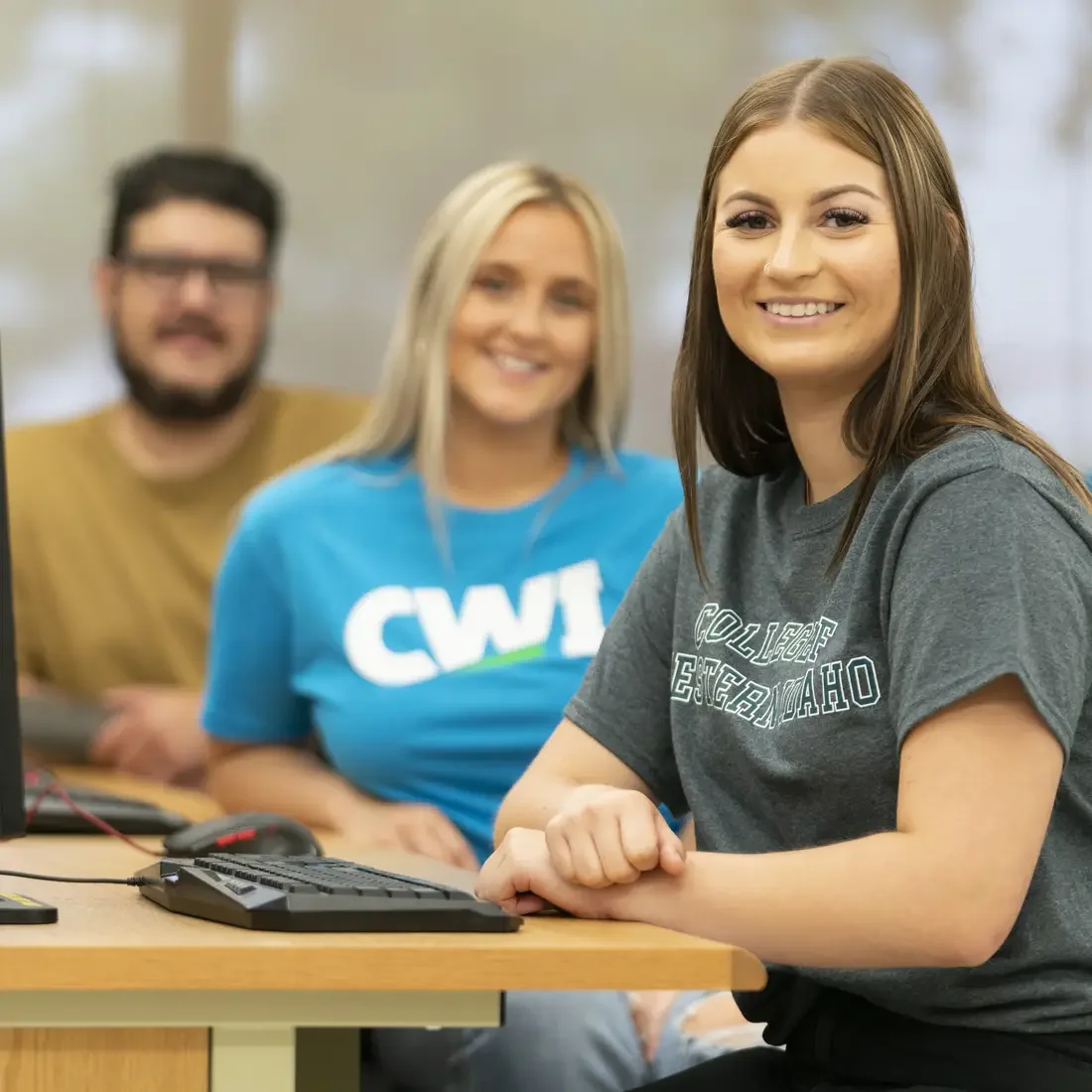 Students sitting at computers on campus