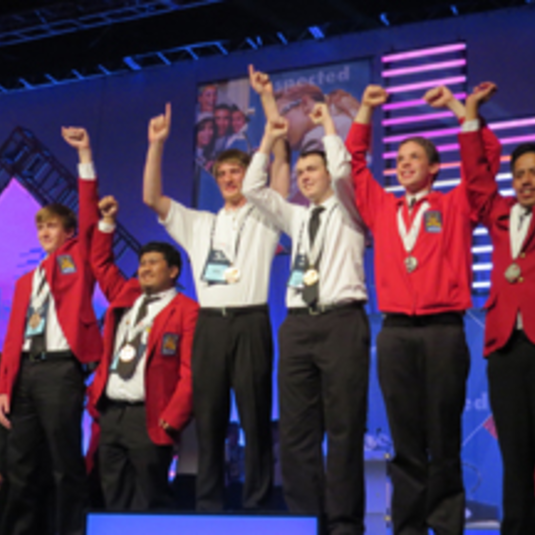 Carlos Gonzales (right) celebrates his silver medal on the podium.