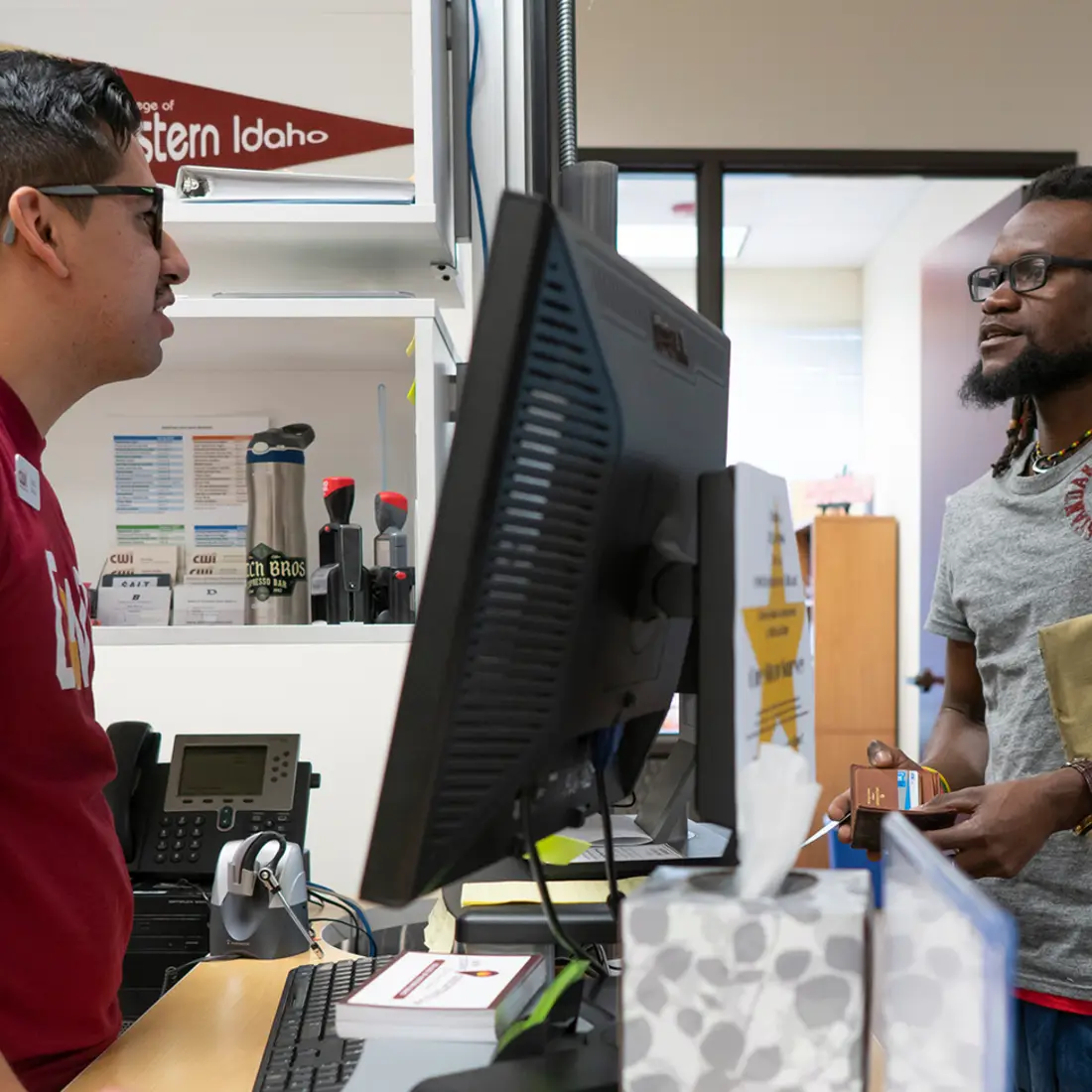 Staff assisting a student at One Stop Student Services.