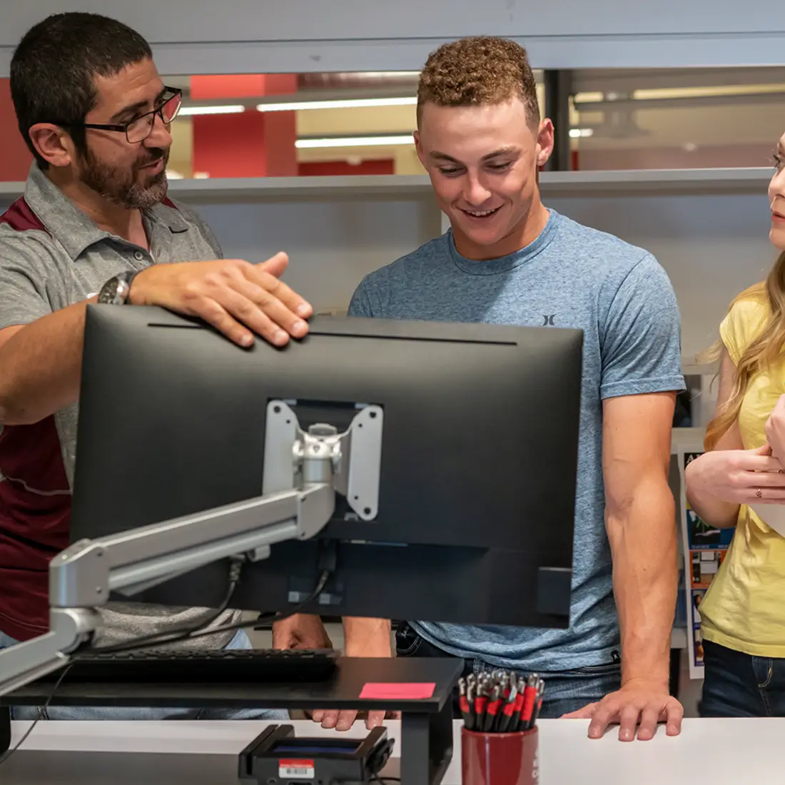 One Stop Representative talking to two students