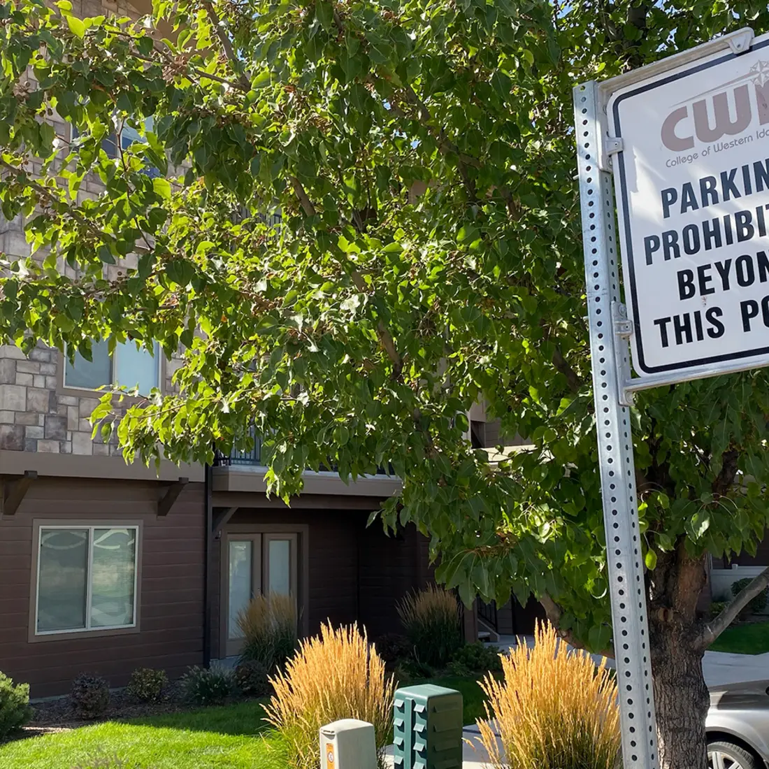 Parking sign next to apartment complex prohibiting CWI parking