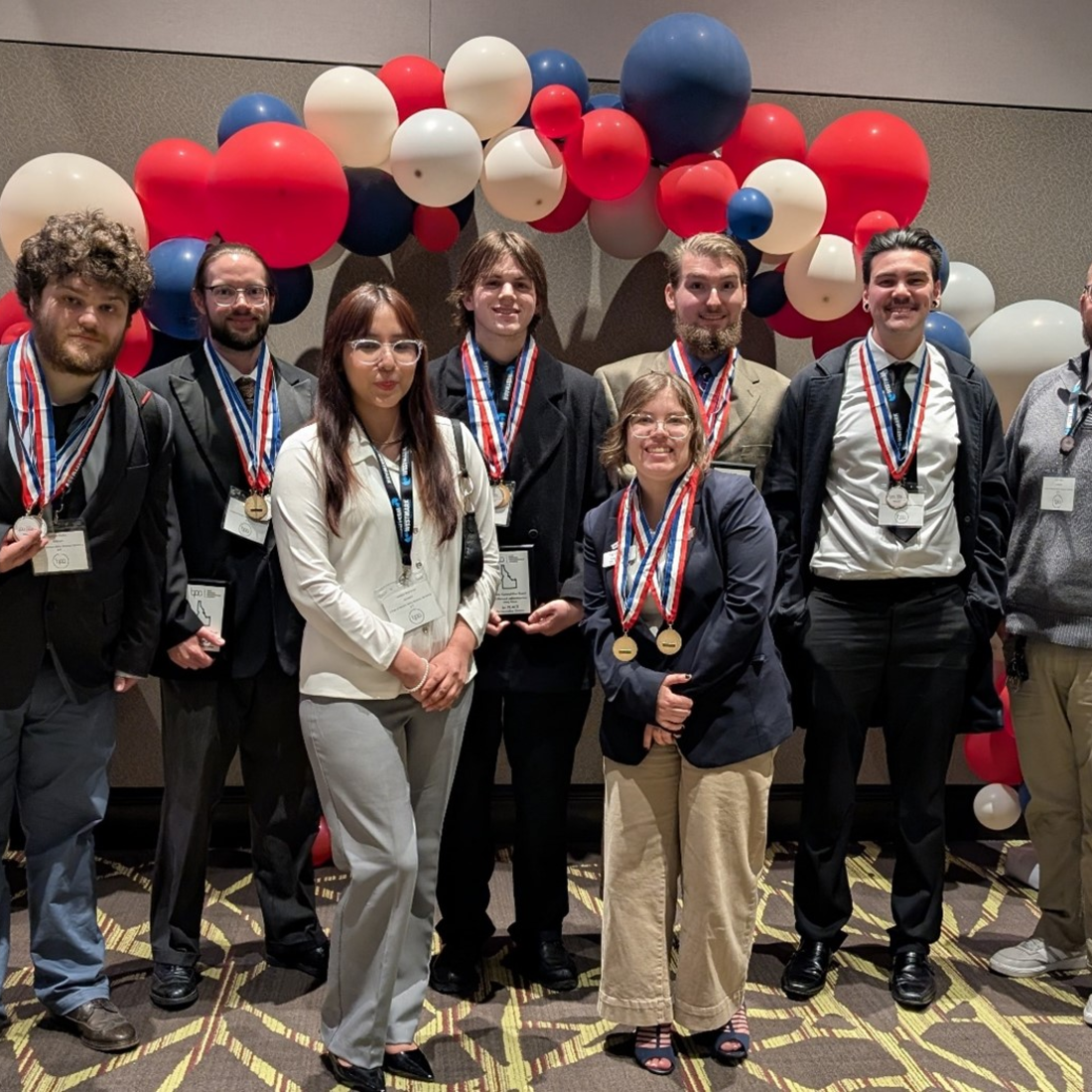 Group of students displaying medals