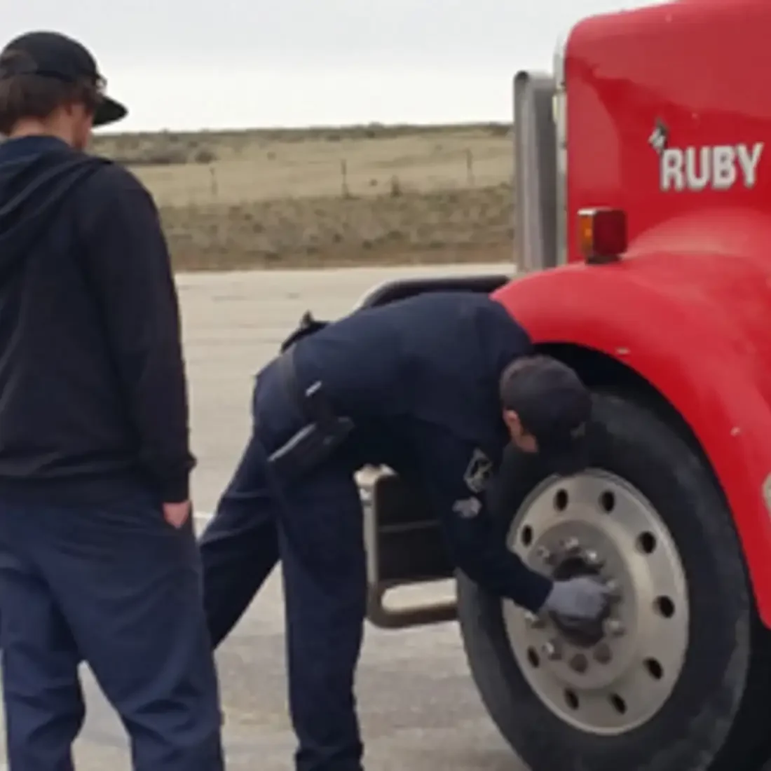 CWI students checking lug bolts on a semi truck