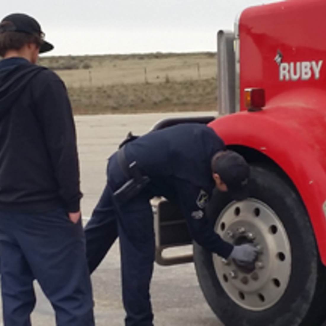 CWI students checking lug bolts on a semi truck
