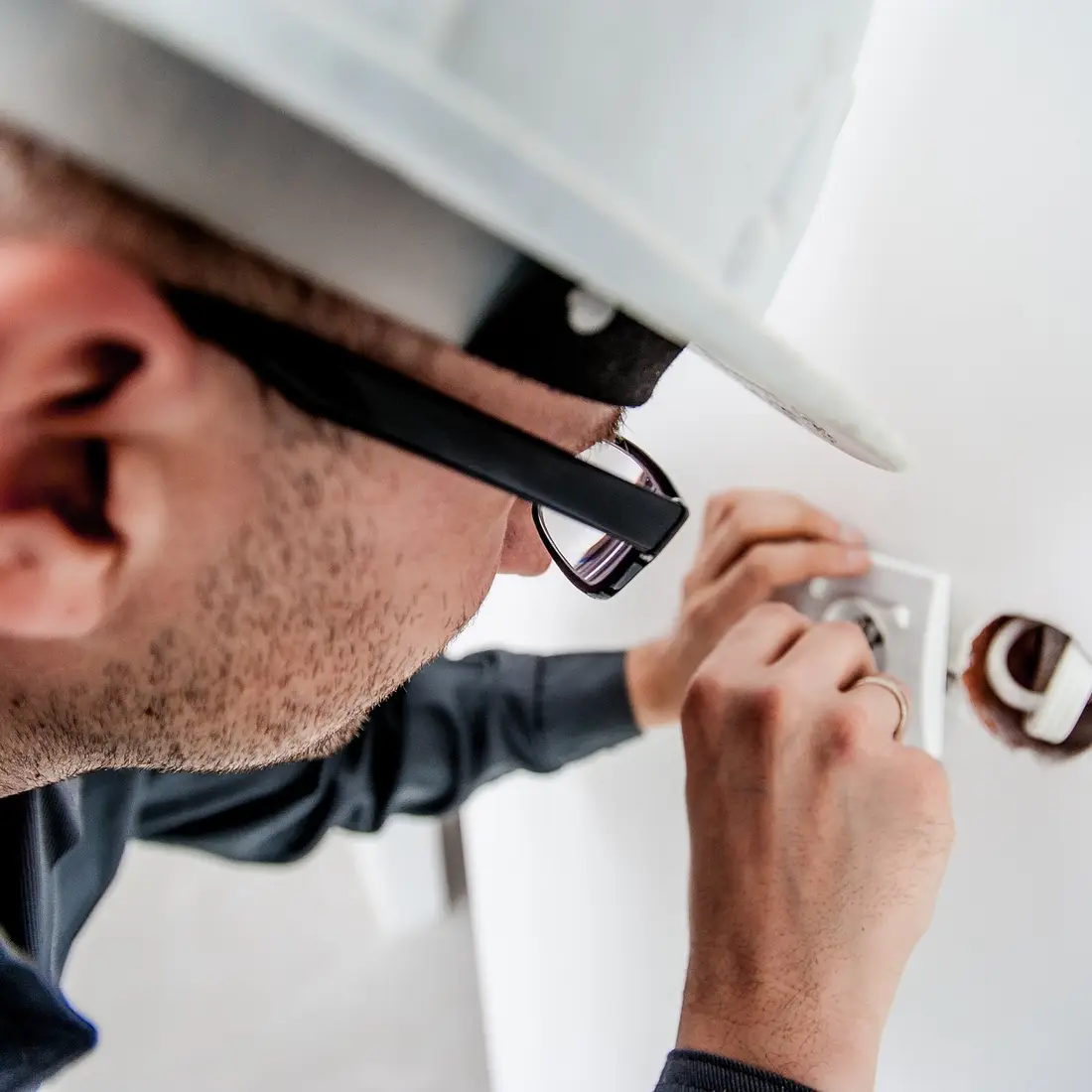 Utility worker doing electrical work indoors