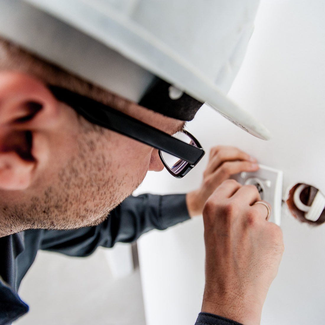 Utility worker doing electrical work indoors