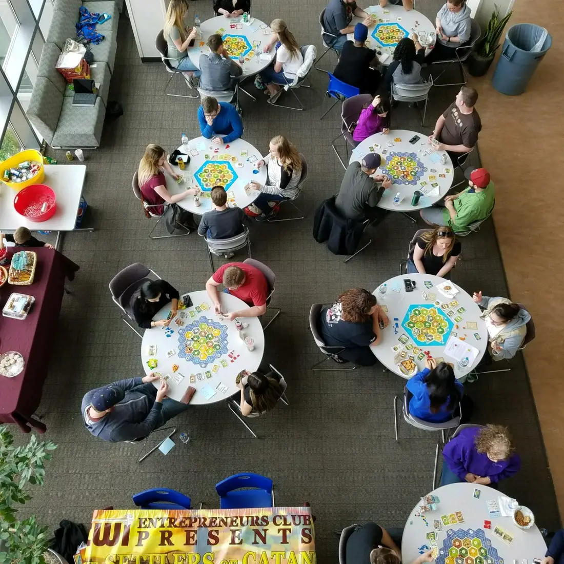 Students at tables playing Settlers of Catan