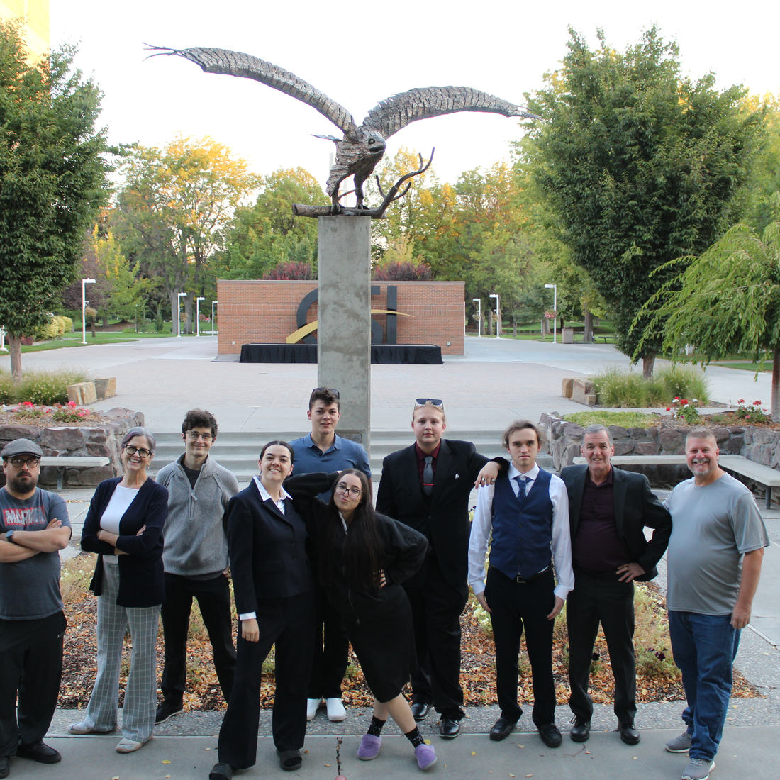 CWI Speech and Debate team posing in front of statue