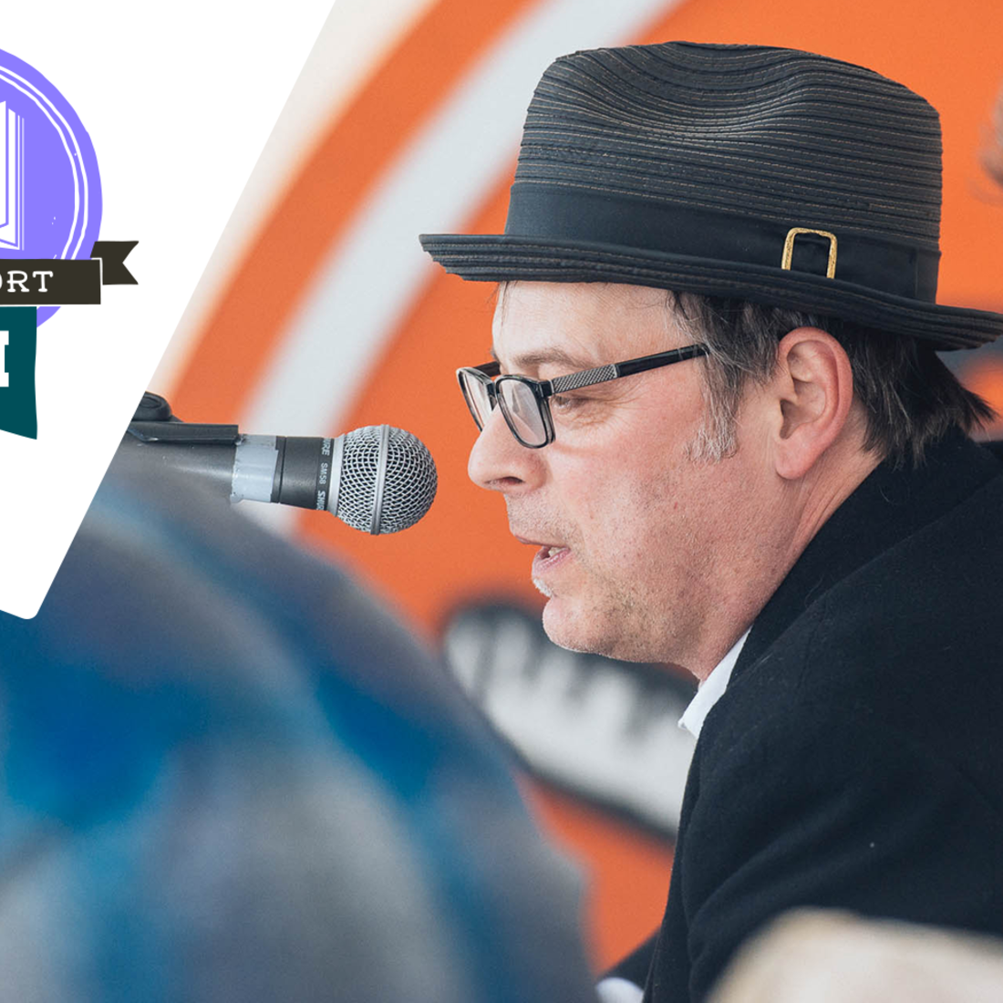 Author, Jonathan Evison, speaking into a microphone