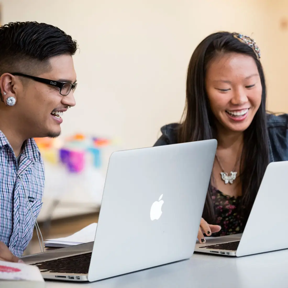 Two students working on laptops