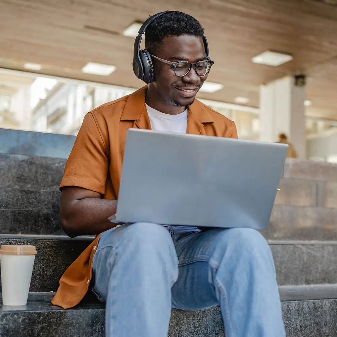 Image is a lifestyle shot showing a busy student fitting in some study time.