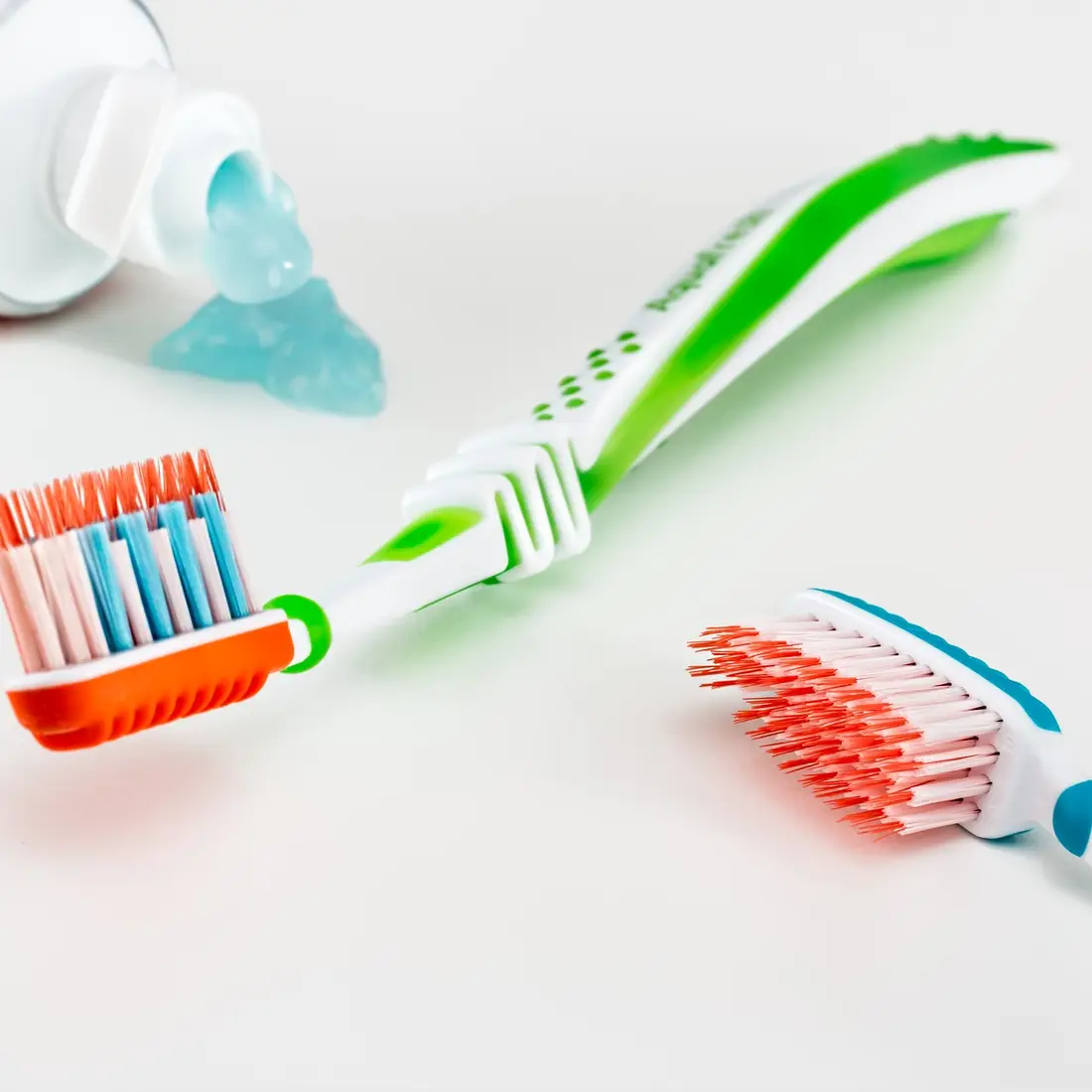 Two toothbrushes and a bottle of toothpaste