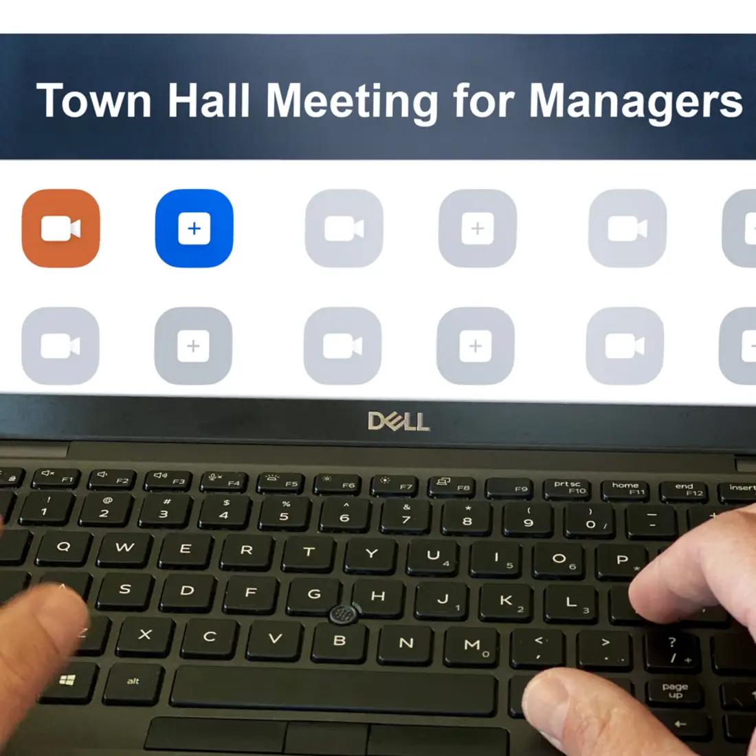 Manager sitting at laptop logging in to Zoom meeting