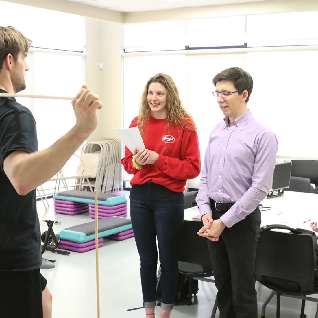 Student and instructor performing a fitness evaluation on an employee in the lab.
