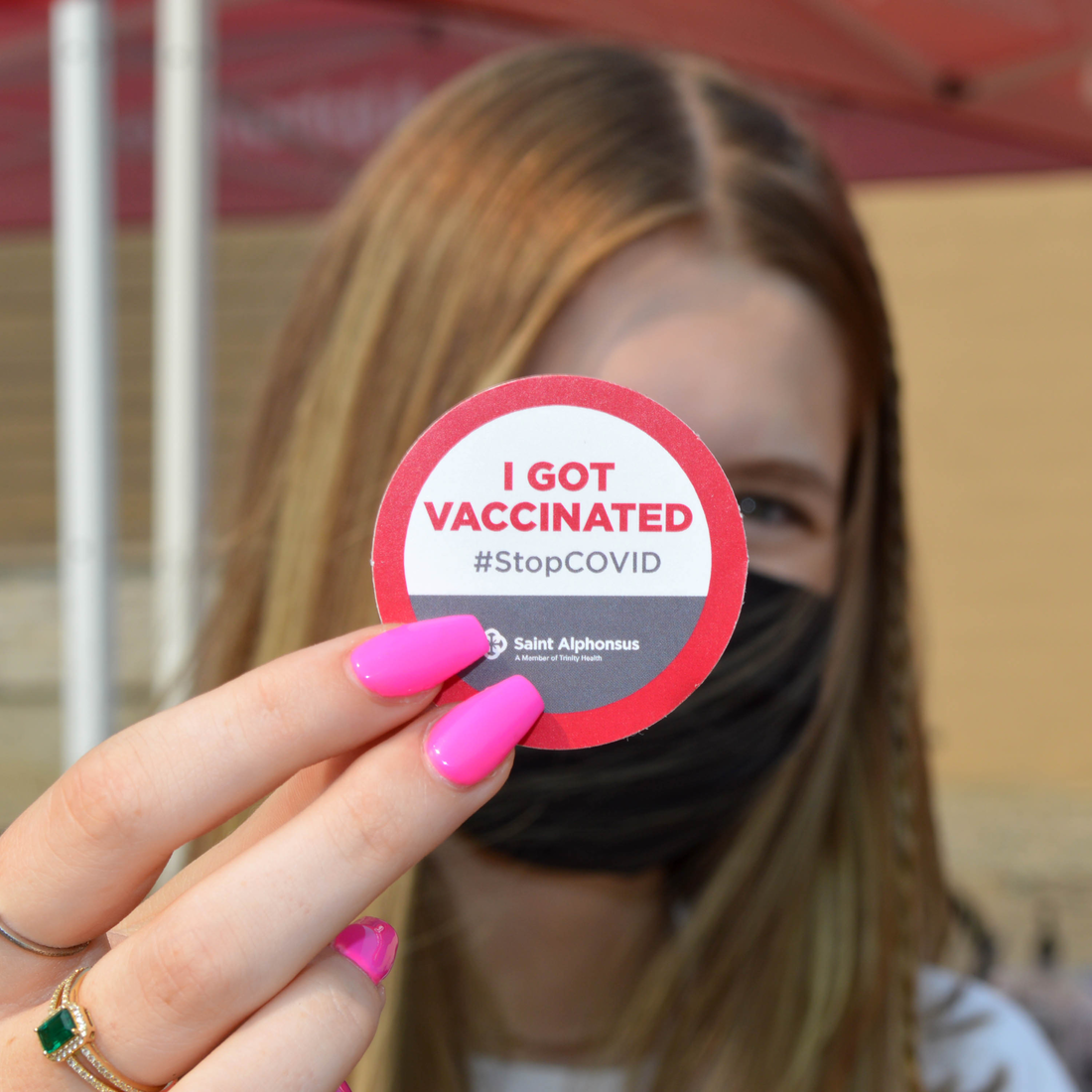individual with a vaccination sticker