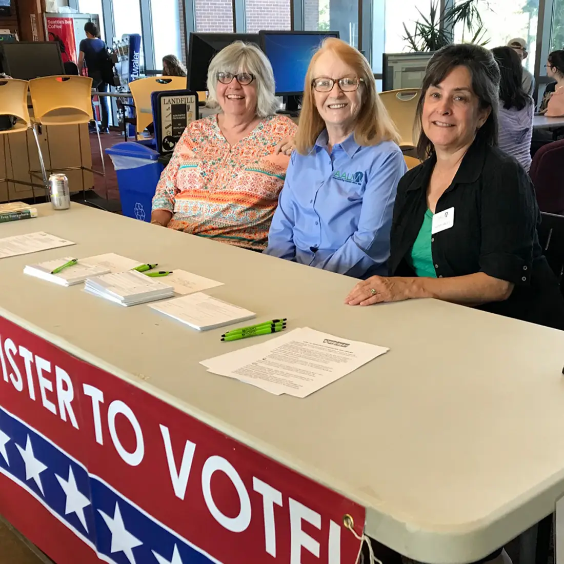 Student leaders and members of AAUW help community members register to vote. 