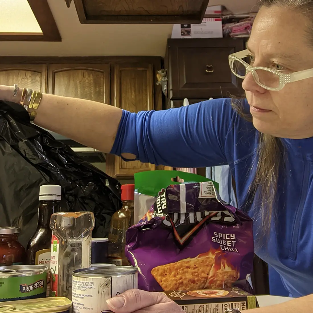 Liz Otterness throwing away food at her home that contain sugar