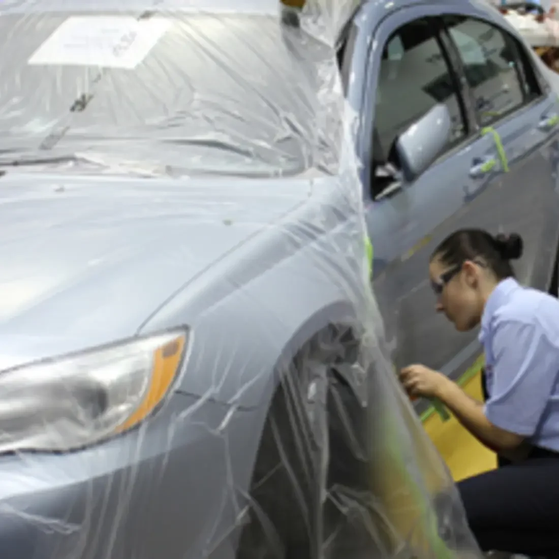 Student painting on car